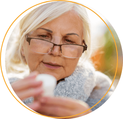 elderly woman reading her PD medication