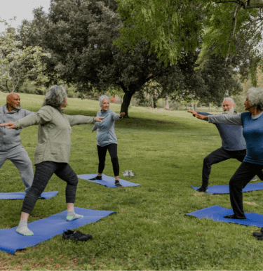 People doing Yoga in a park