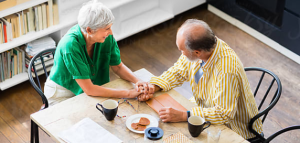 A elderly couple sitting at a table