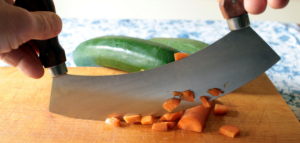 Carrots being chopped on a cutting board