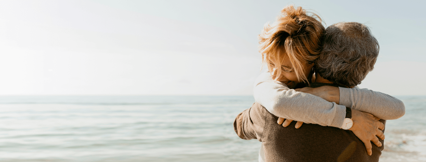 a couple hugging on a beach