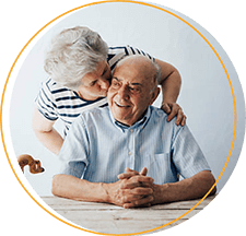 Elderly woman kissing elderly man on cheek